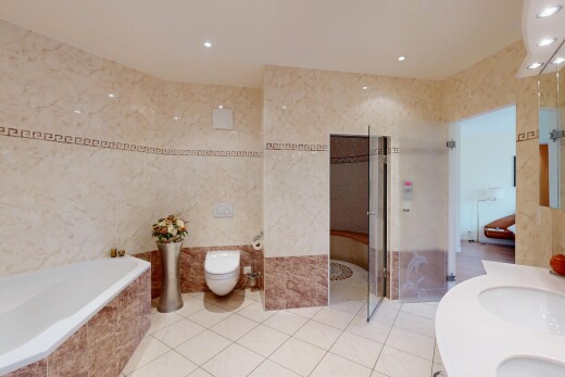 full bathroom featuring double vanity, tile walls, a garden tub, recessed lighting, and tile patterned flooring