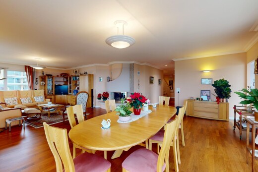 living / dining room featuring wood finished floors and crown molding