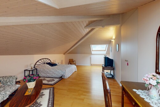 room featuring a skylight, light wood-type flooring, and wooden ceiling