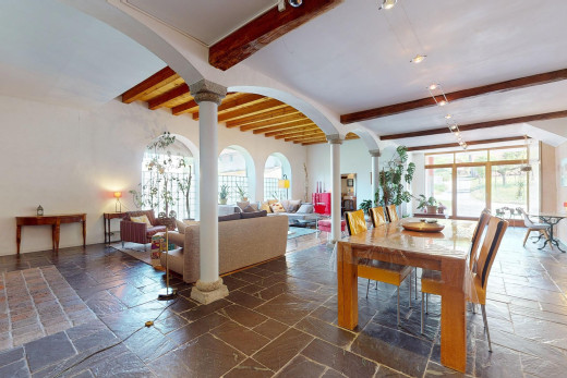 esszimmer mit fliesenboden, dekorative säulen, balkendecke, und natürliches licht