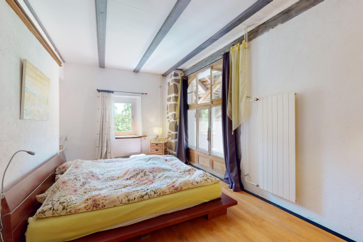 zimmer / schlafzimmer mit kühler, parkettboden, balkendecke, und natürliches licht