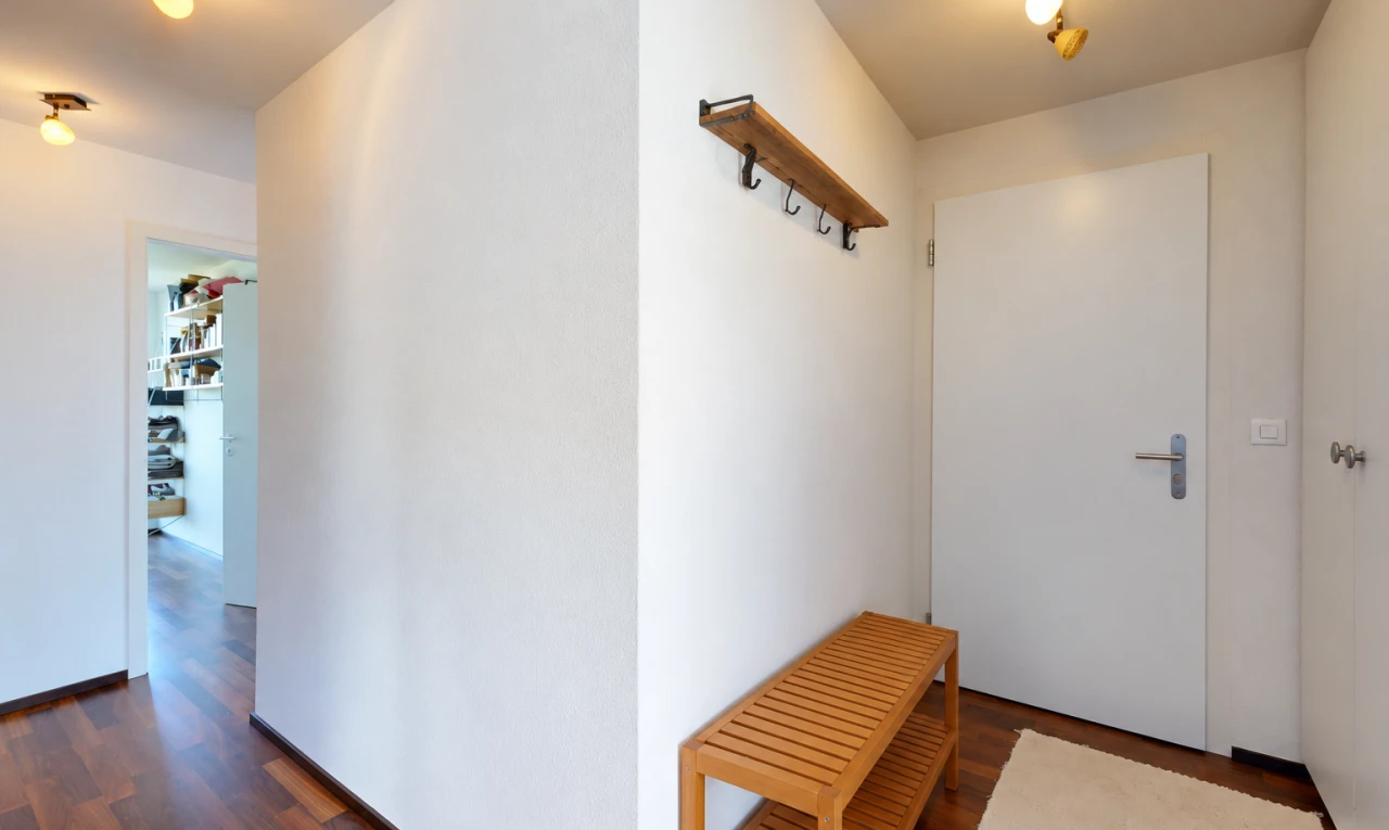 couloir avec drywall, cloison sèche, inside property, wood finish floor, et sol en finition bois