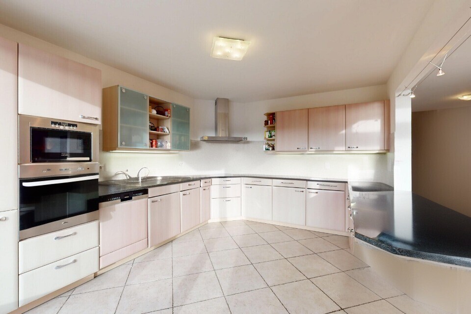 kitchen with wall chimney exhaust hood, white dishwasher, double oven, light tile patterned flooring, and open shelves