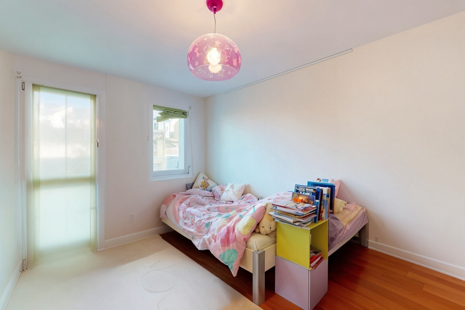 room / bedroom featuring baseboards and wood finished floors