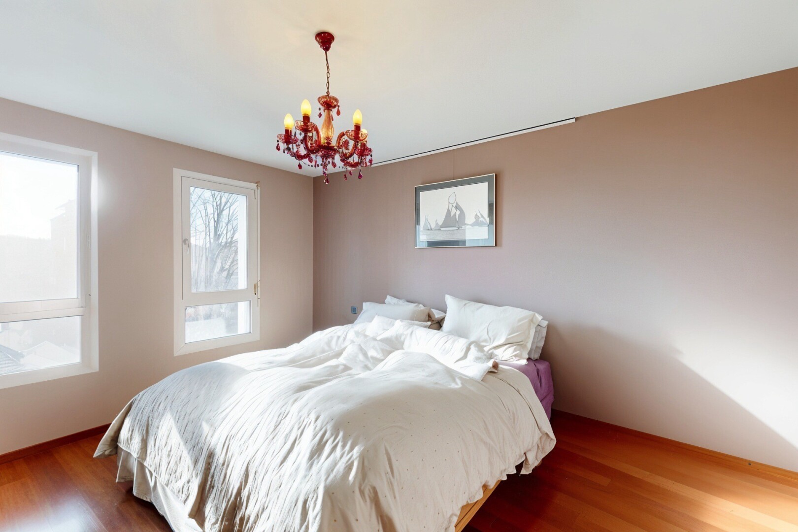 room / bedroom featuring wood finished floors and a chandelier