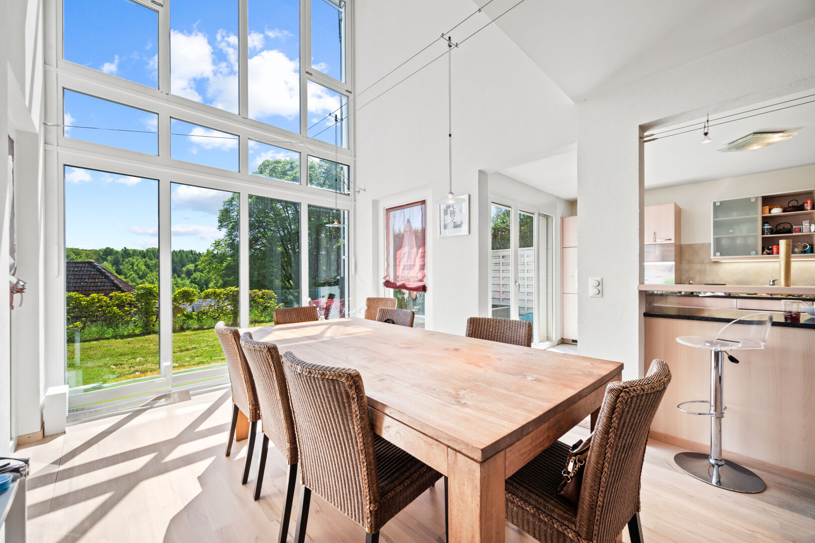 dining space featuring a high ceiling and light wood-style flooring
