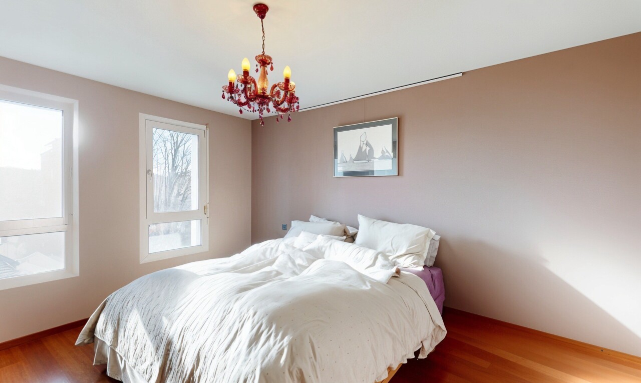 room / bedroom featuring wood finished floors and a chandelier
