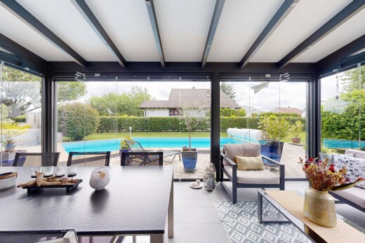 patio / terrace featuring outdoor seating, an outdoor pool, and a sunroom