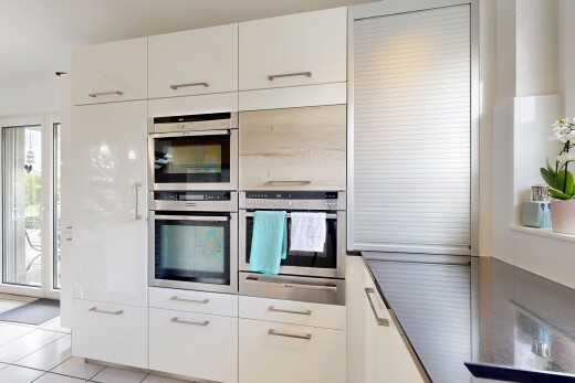 kitchen featuring double oven, white cabinets, modern cabinets, and light tile patterned flooring