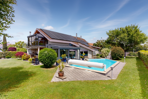outdoor pool with a lawn, a patio area, and a balcony