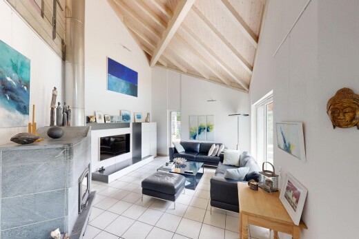 living area featuring lofted ceiling, healthy amount of natural light, and light tile patterned flooring