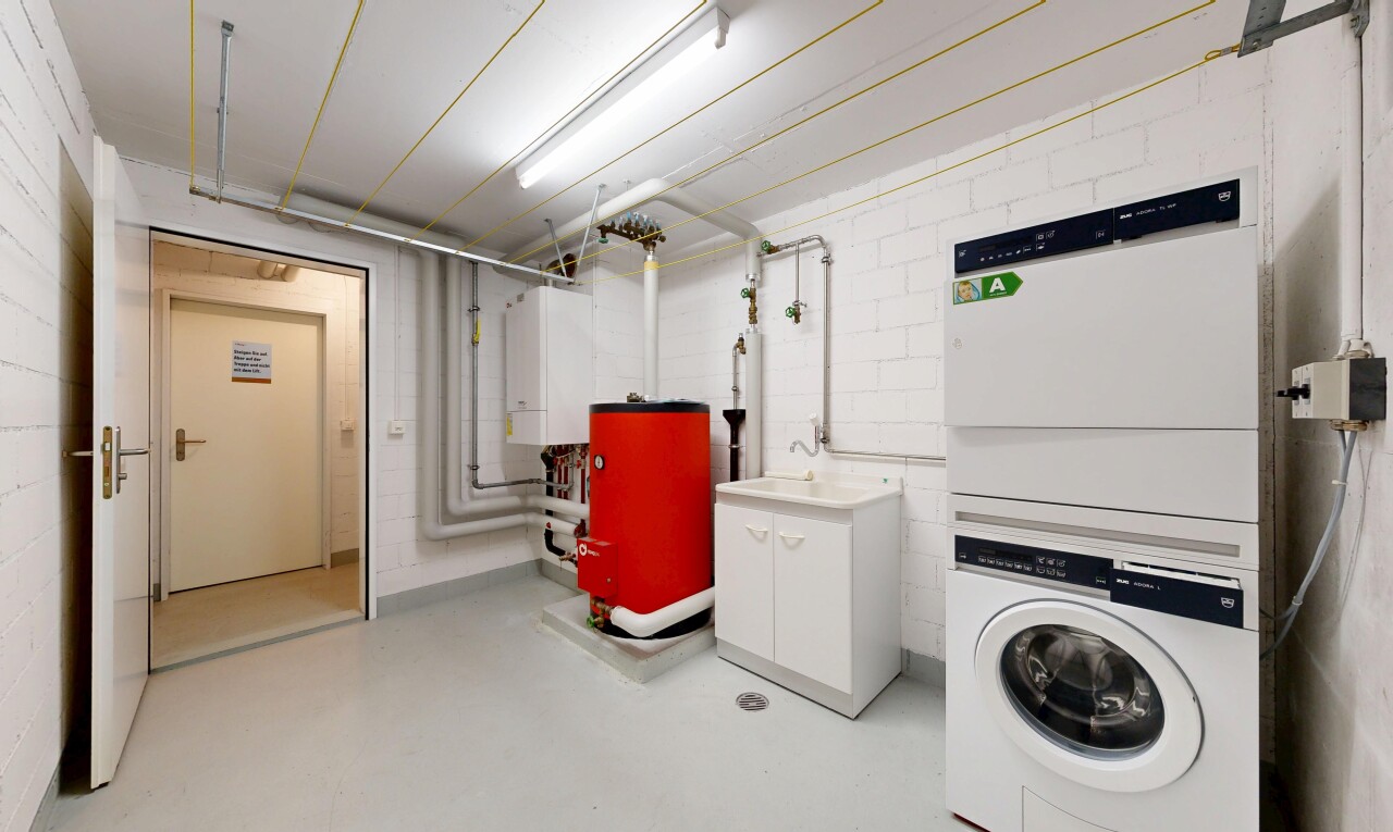 wäschekammer mit light floor, heizkessel, inside community, concrete floor, und finished concrete floor