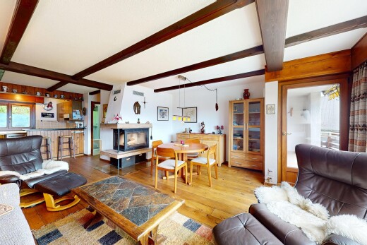 living / dining area featuring beamed ceiling and hardwood / wood-style flooring