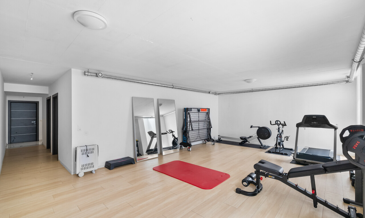 gym avec sol en finition bois, wood finish floor, inside property, cloison sèche, et drywall