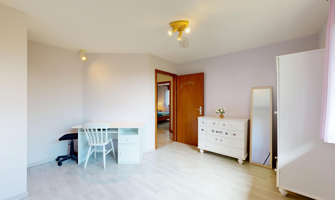 room / bedroom featuring a desk and light wood-style flooring