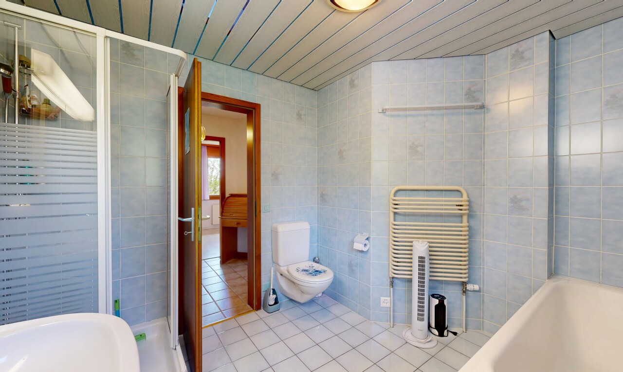bathroom with tile walls, an enclosed shower, wood ceiling, a towel warmer, and radiator heating unit