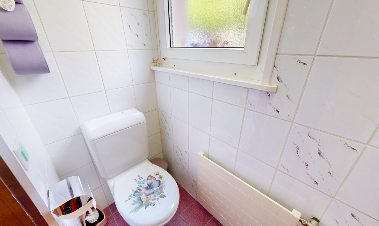 half bathroom featuring tile walls, radiator heating unit, and tile patterned floors
