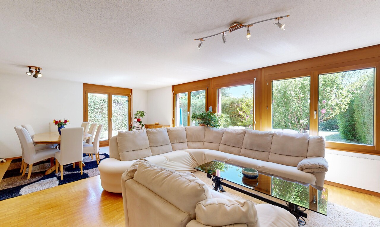 living room with track lighting and light wood-style flooring
