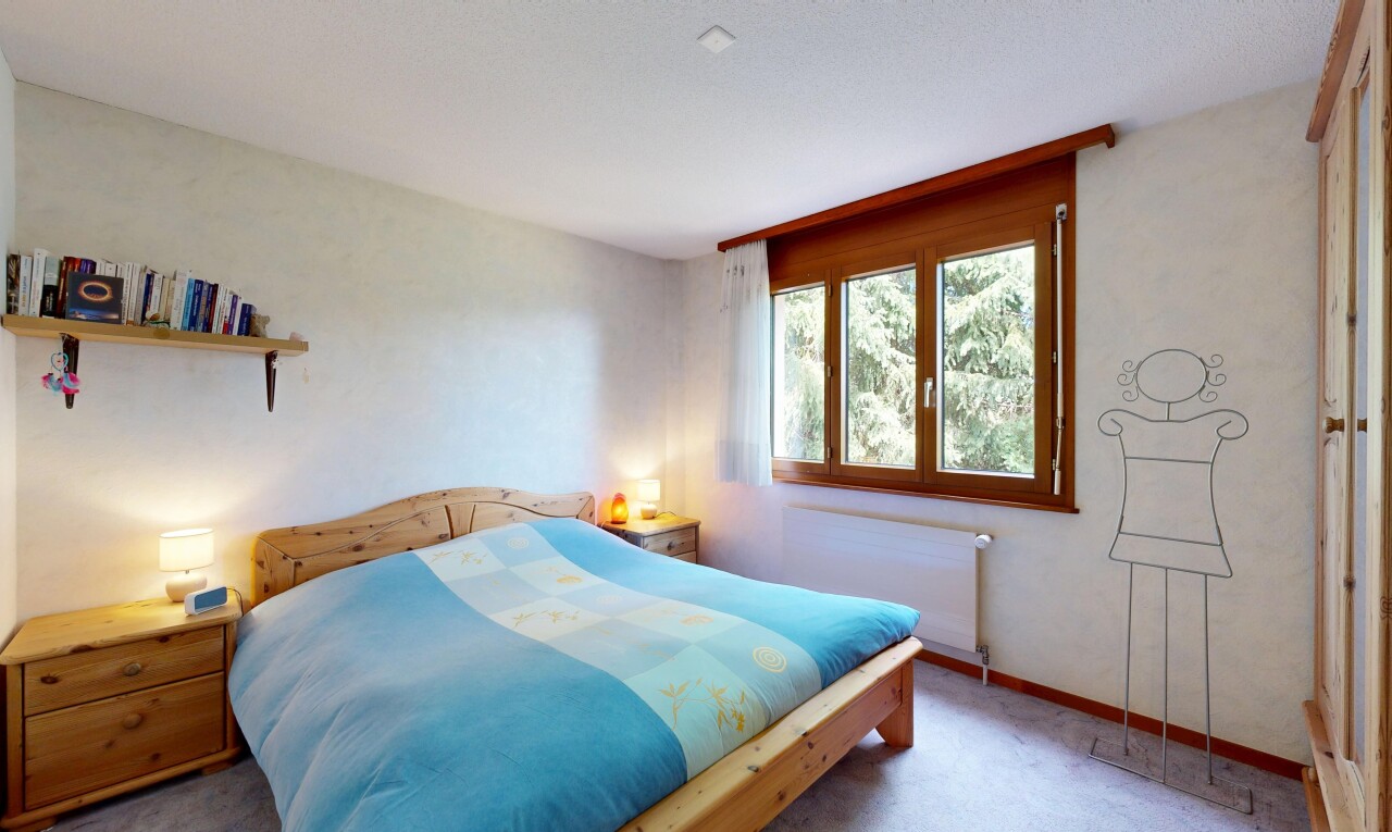carpeted room with radiator heating unit and baseboards