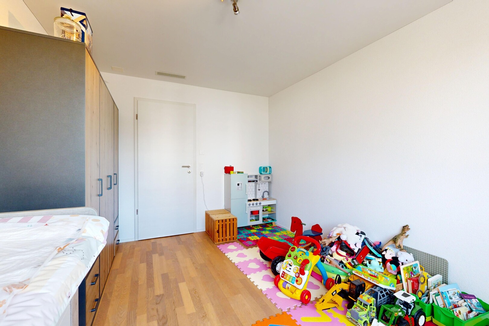 zimmer / schlafzimmer mit wood finish floor, holzfußboden, drywall, gipskartonwand, und inside property
