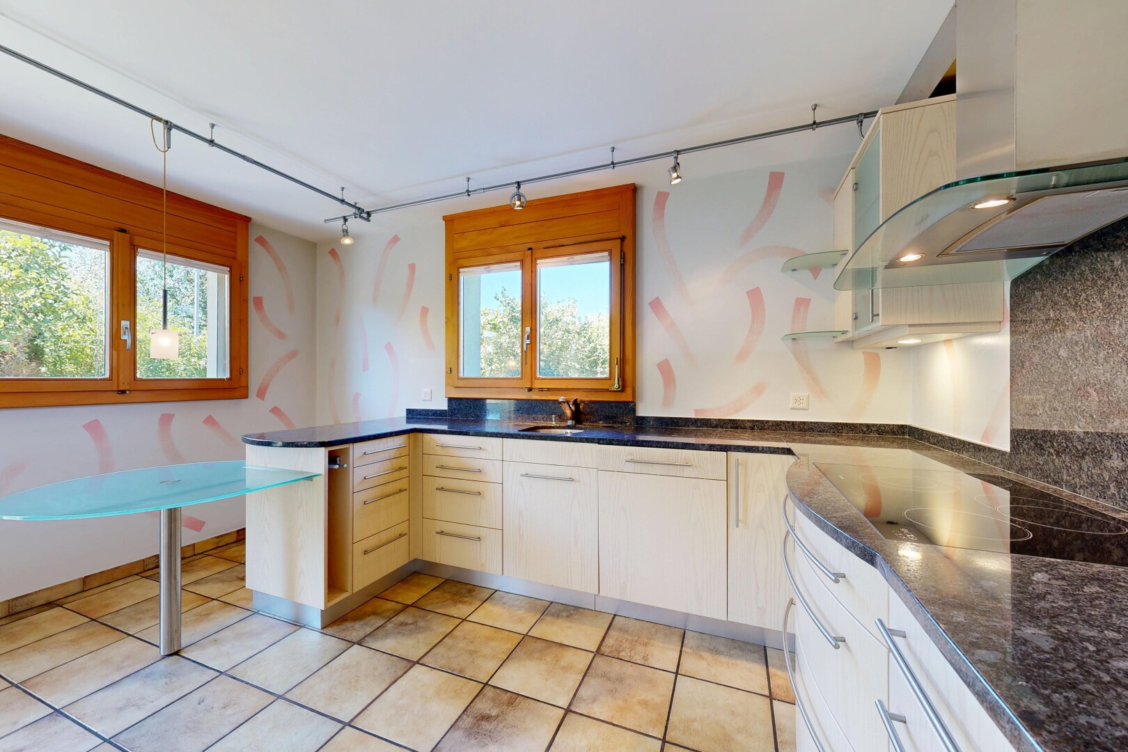 küche mit dunstabzugshaube, dark countertops, light floor, stein arbeitsplatten, und stone countertops