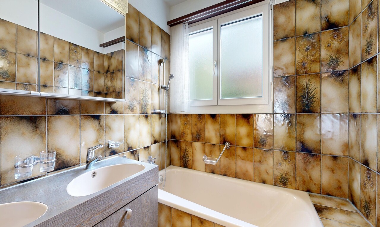 salle de bains avec salle de bain complète, miroir, double vasque, inside property, et évier