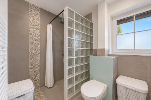 salle de bains avec mur en carrelage, tile wall, douche, salle de bain complète, et toilette