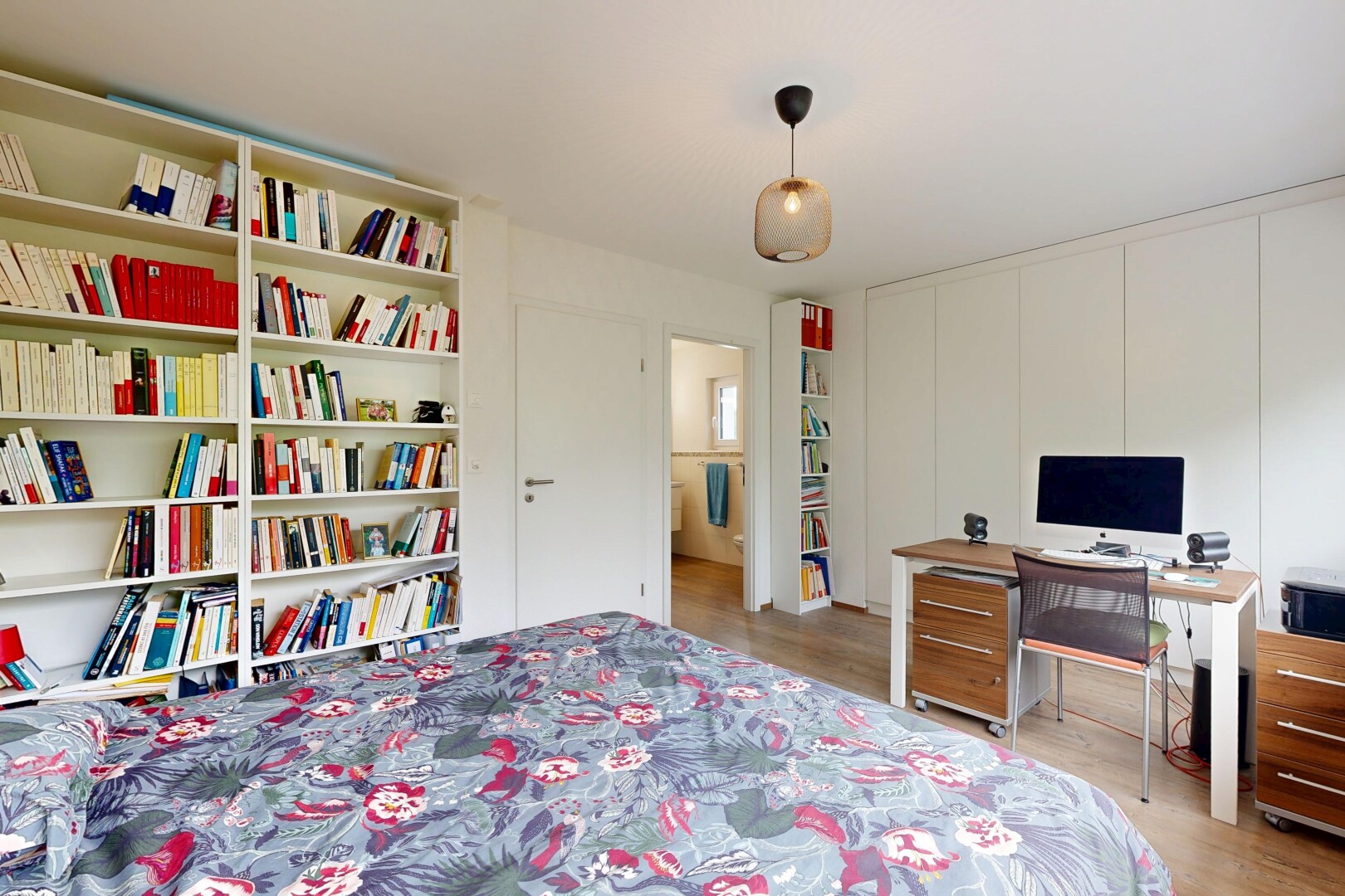chambre avec inside property, télévision, sol en finition bois, wood finish floor, et light floor