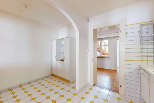 couloir avec plancher de bois, carrelage, lumière naturelle, passerelles voûtées, et mur carrelé