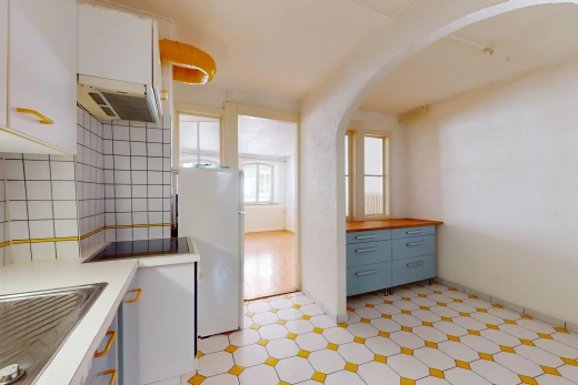 cuisine avec réfrigérateur, plancher de bois, carrelage, lumière naturelle, et hotte