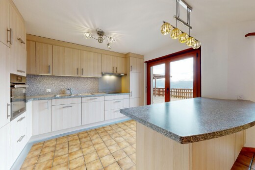 kitchen with a peninsula, french doors, stainless steel oven, and dark countertops
