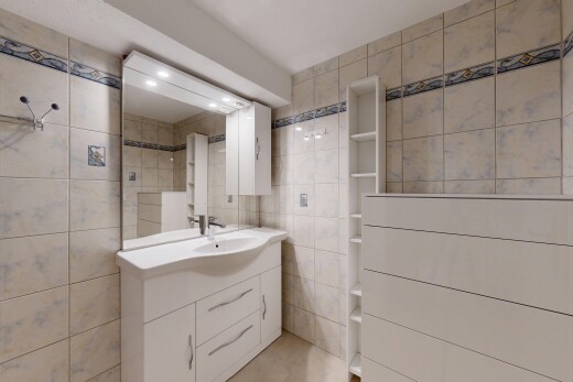 bathroom featuring tile walls and vanity