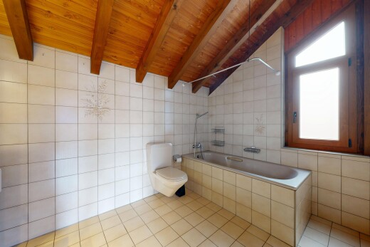 full bathroom with tile walls, lofted ceiling with beams, tiled shower / bath combo, wood ceiling, and light tile patterned floors