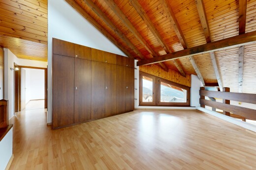 unfurnished room with a high wooden beamed ceiling, light wood-style flooring, and wood walls