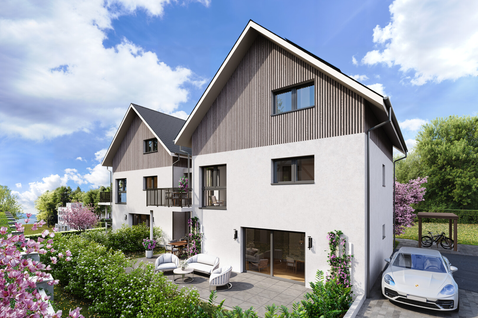 view of home featuring board and batten siding, a balcony, and a patio area