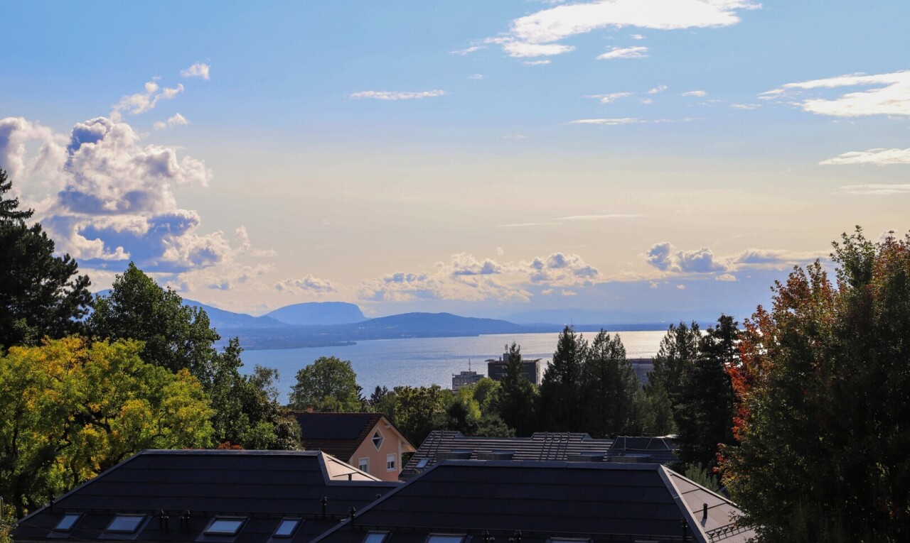 view of mountain background featuring a nearby body of water