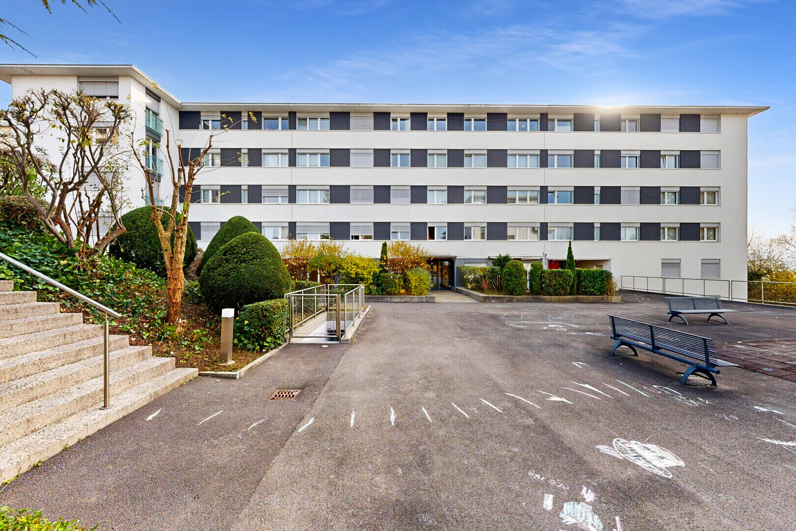 view of apartment building / complex featuring uncovered parking
