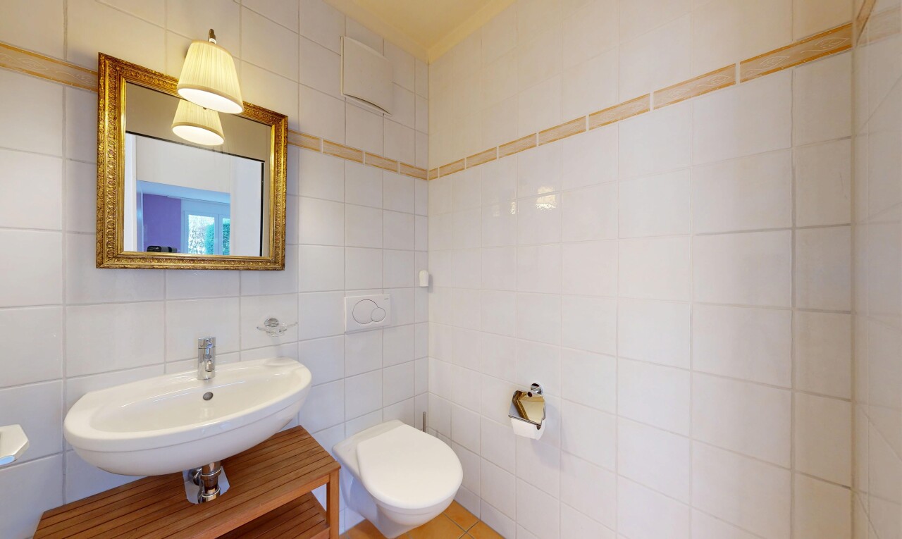 half bath featuring tile walls