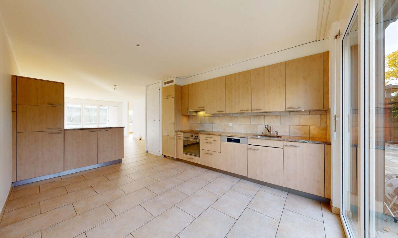 kitchen with light wood finish cabinetry, stainless steel appliances, tasteful backsplash, modern cabinets, and light stone counters