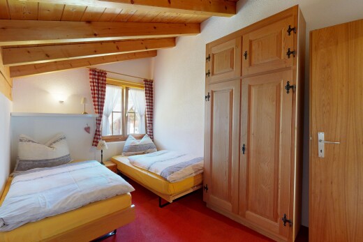 room / bedroom with vaulted ceiling with beams, a closet, dark colored carpet, and wooden ceiling