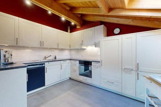 kitchen with vaulted ceiling with beams, oven, white cabinetry, tasteful backsplash, and light countertops