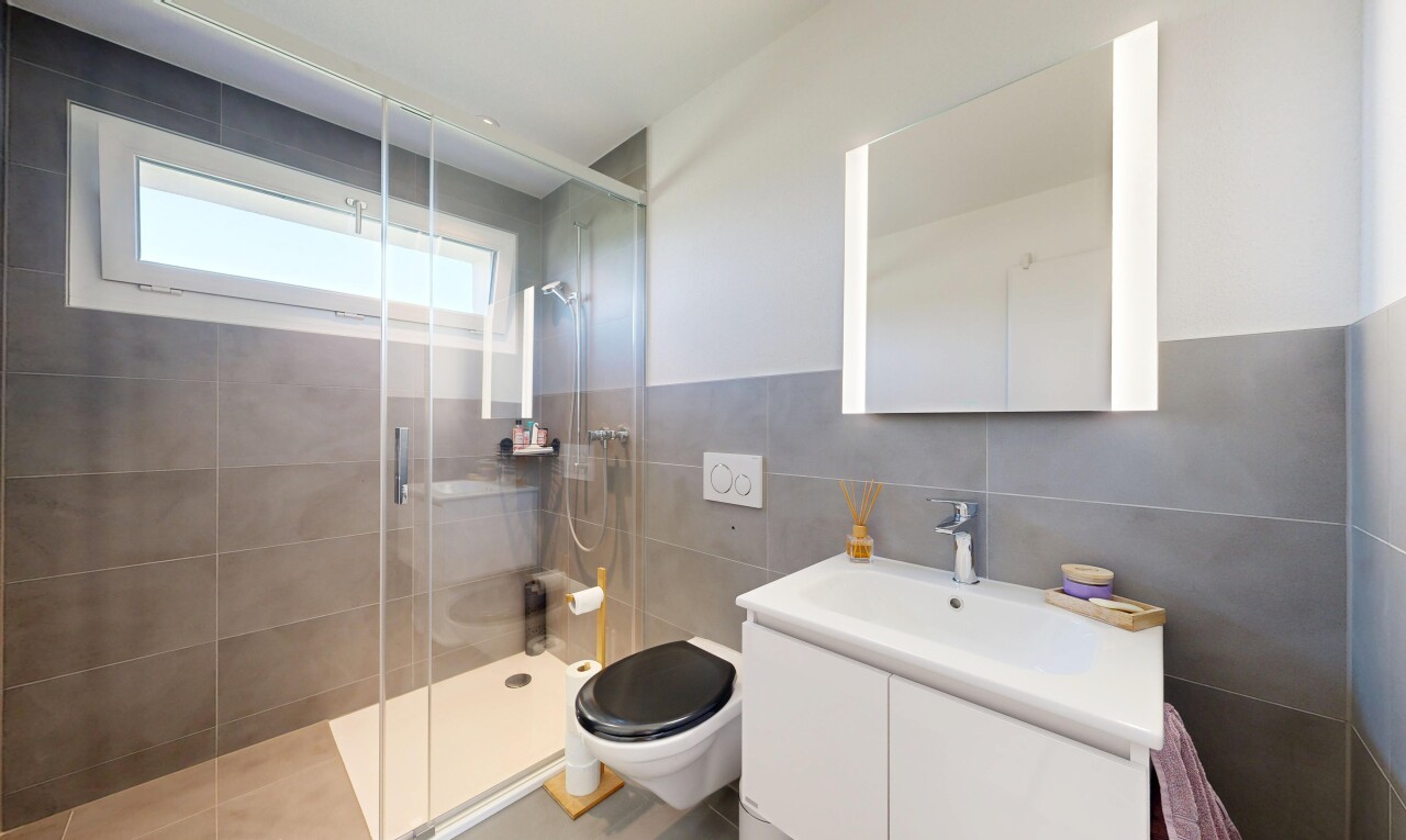 salle de bains avec douche, salle de bain complète, mur en carrelage, tile wall, et lavabo (ou coiffeuse selon le contexte)