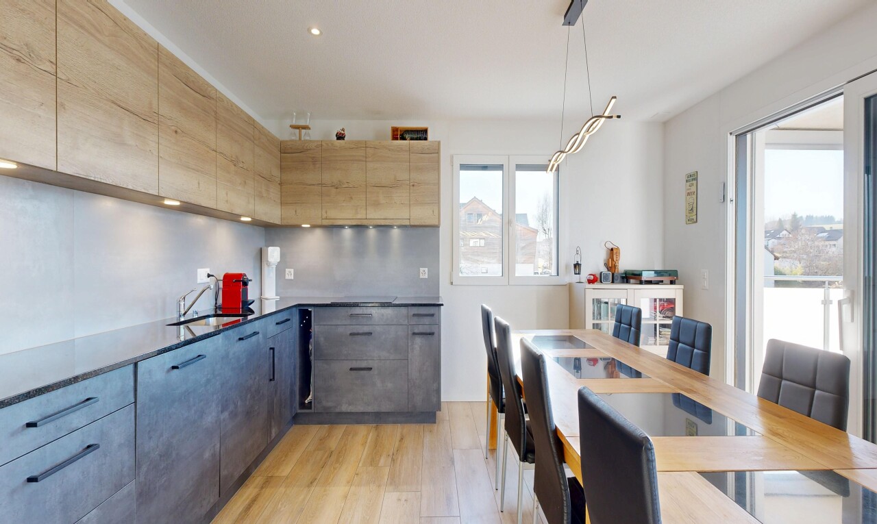 kitchen with light wood-style floors, modern cabinets, pendant lighting, and dark stone counters