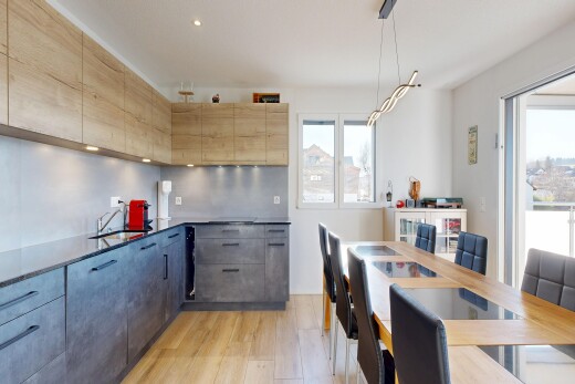 kitchen with light wood-style floors, modern cabinets, pendant lighting, and dark stone counters