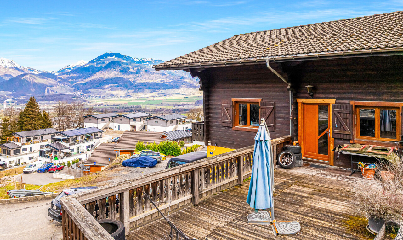 terrace with a residential view and a deck with mountain view