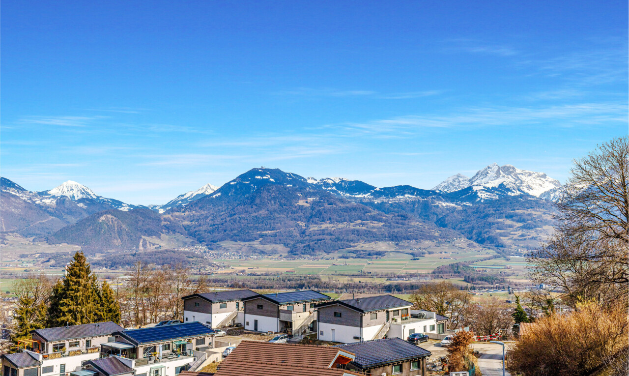 view of mountain backdrop with nearby suburban area