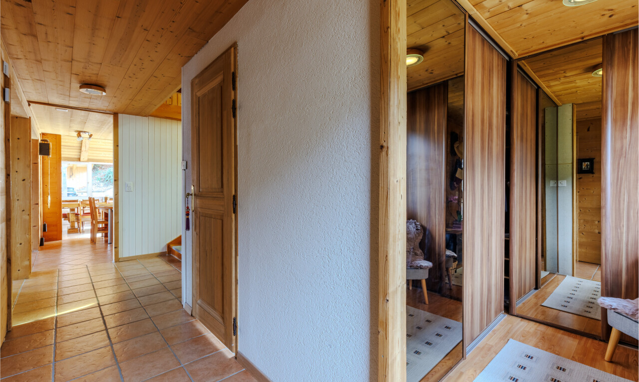corridor featuring wooden ceiling, a textured wall, and a relaxing sauna