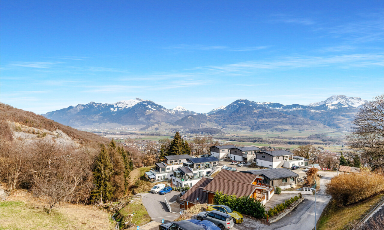 view of mountain background featuring nearby suburban area