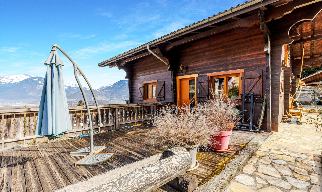 outdoor house featuring a deck with mountain view