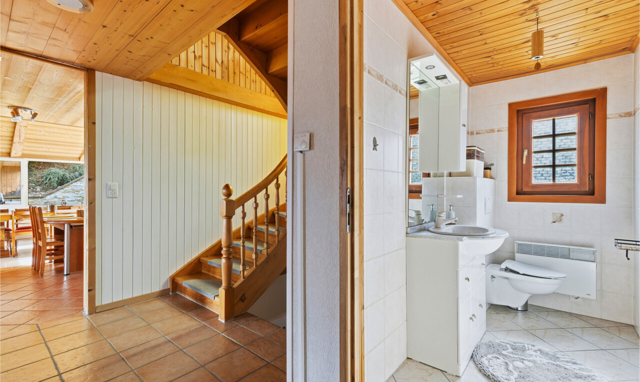 bathroom with wood ceiling, vanity, light tile patterned flooring, and heating unit